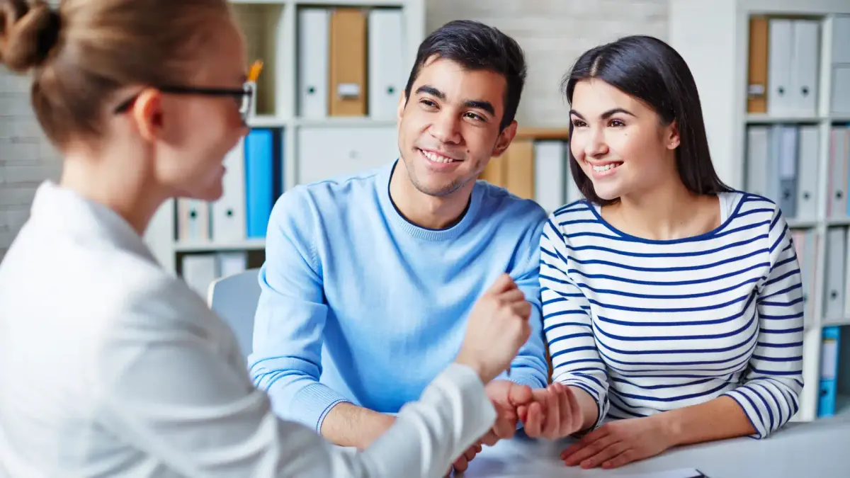 a person looking at a couple and smiling