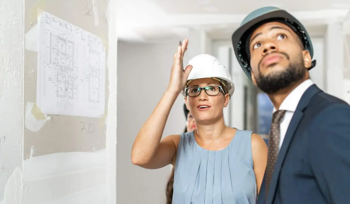 real estate investor talking with a construction manager on site