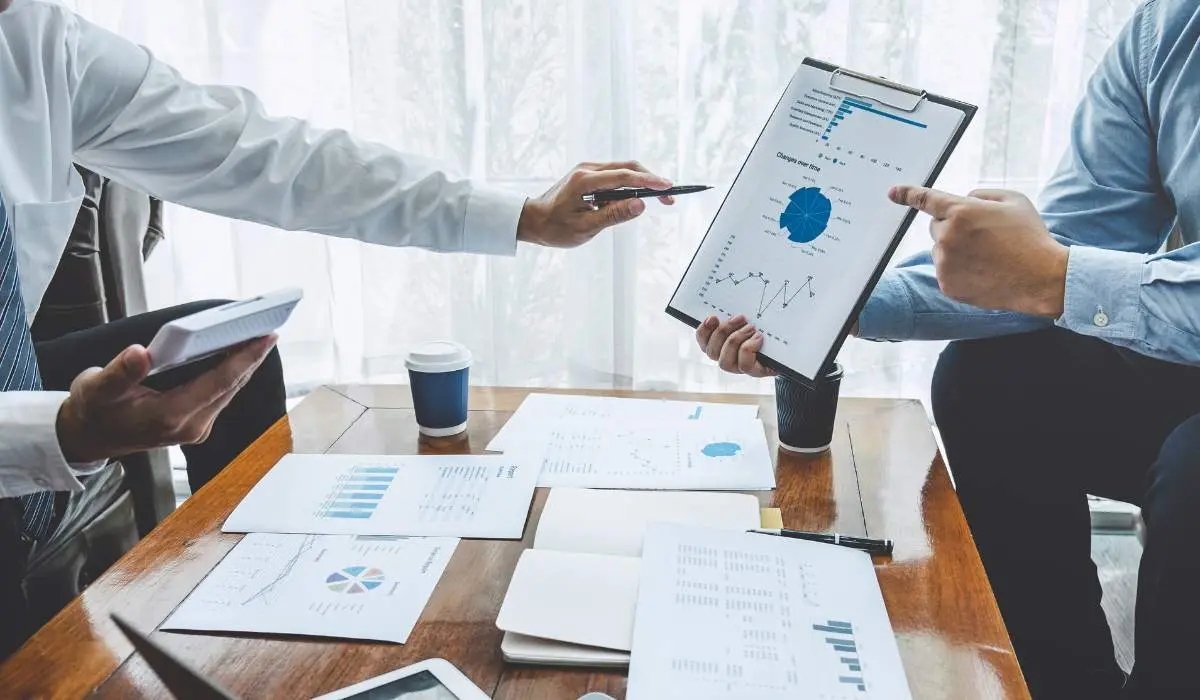 two people discussing investment portfolio on an ipad