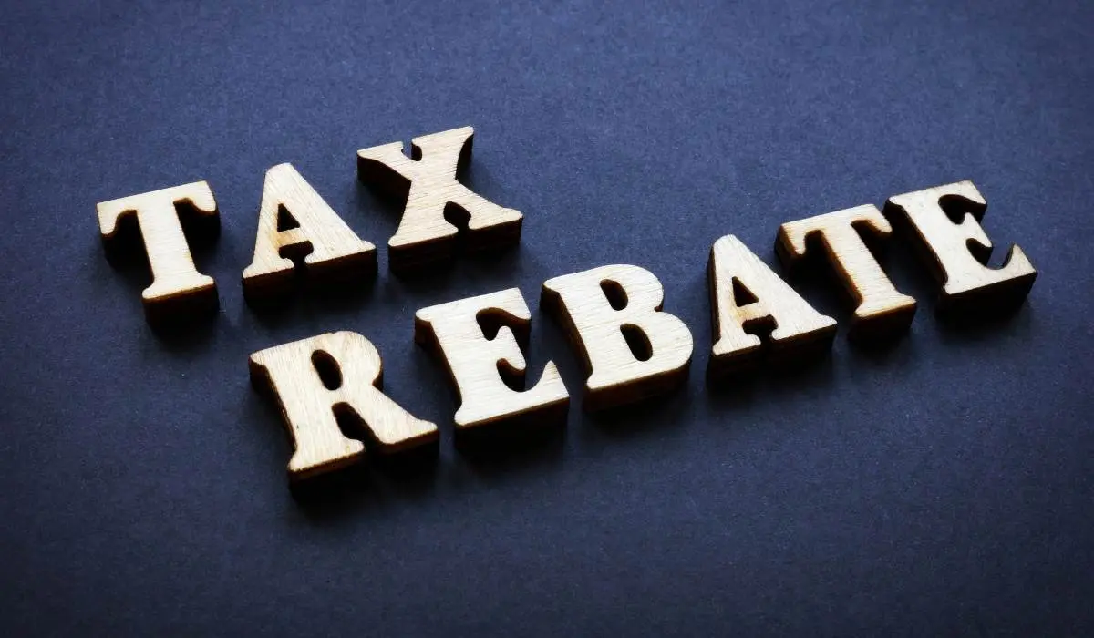 tax rebate(wooden cut outs) on a blue carpet
