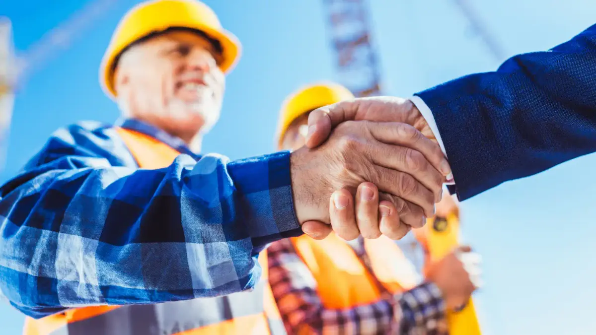 a builder shaking hands with another person