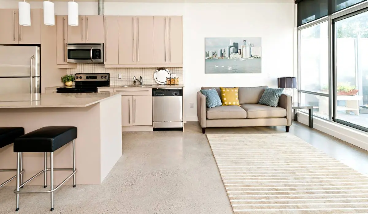 an open kitchen and living room area in a modern pre-construction condo