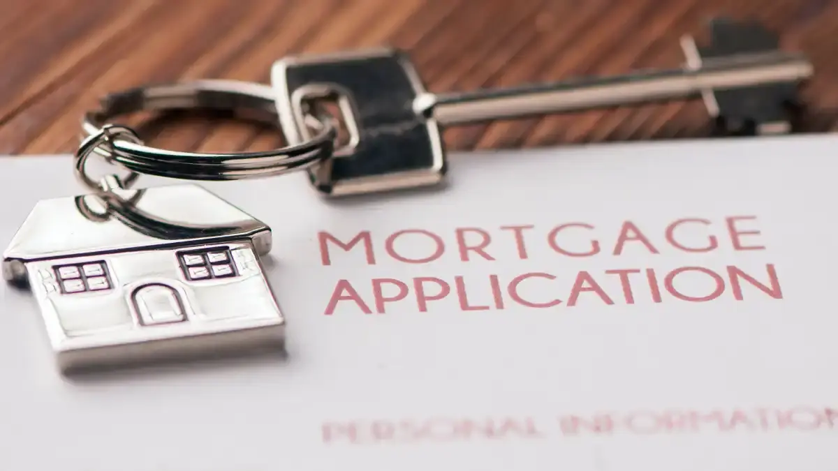 mortgage application with house keys placed on it