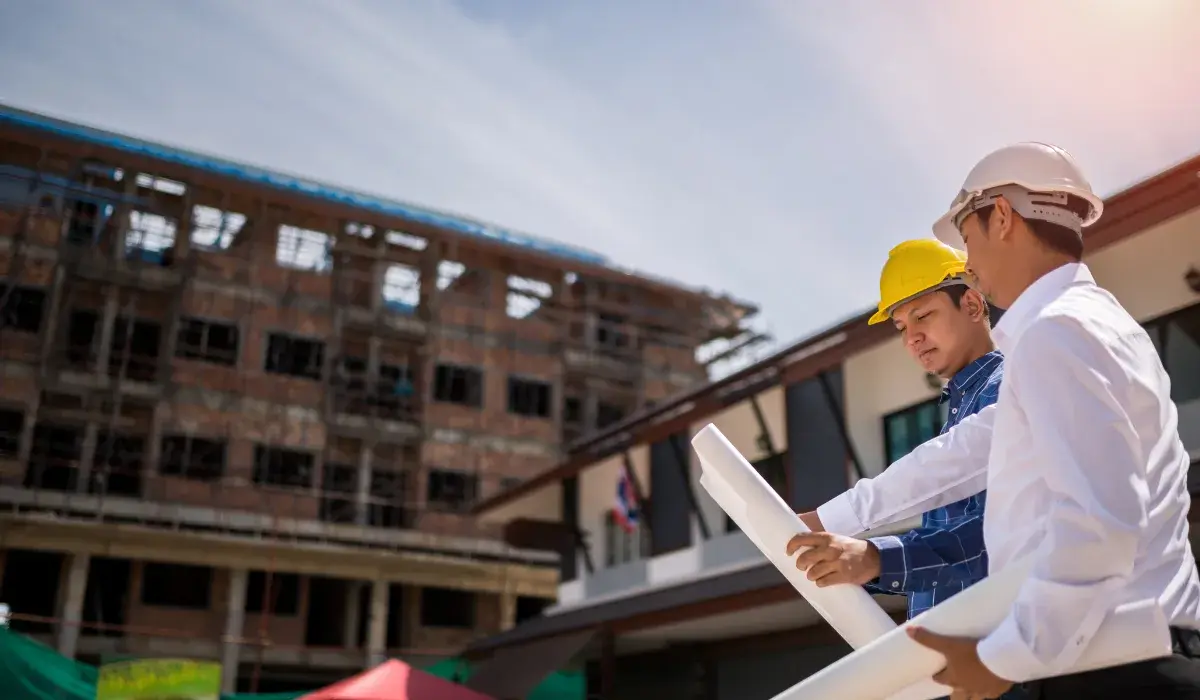 two workers standing in front of a building